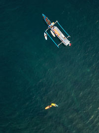 Aerial view of surfers and boat in the ocean, lombok, indonesia