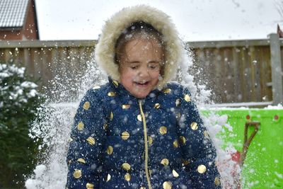 Happy girl standing in snow