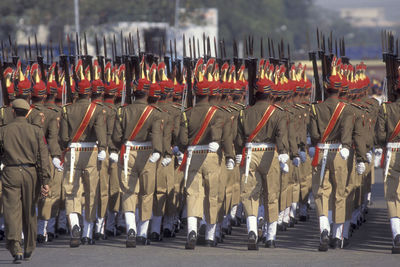 Rear view of soldiers standing on street