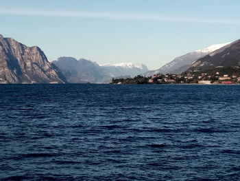 Scenic view of sea and mountains against sky