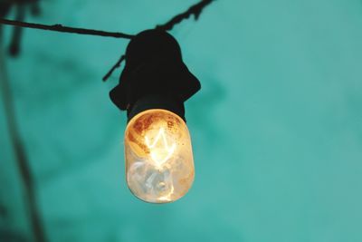 Low angle view of illuminated light bulb