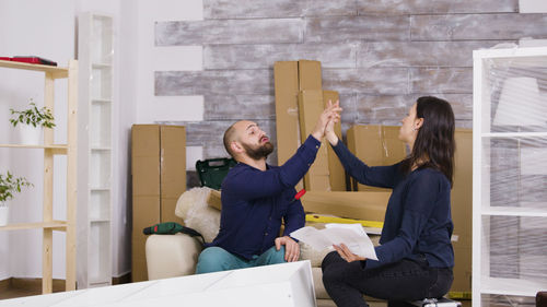 Couple sitting on sofa at home