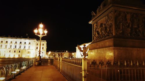 Statue in city at night