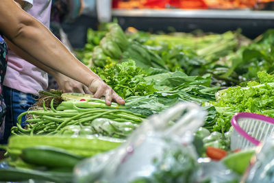 Midsection of man for sale at market stall