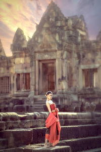 Young woman standing outside historic temple