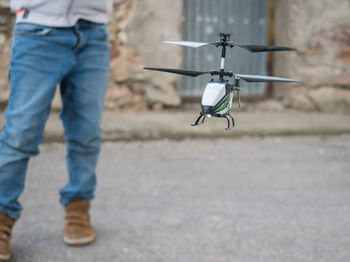 Child playing with radio-controlled helicopter.