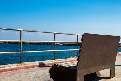A bench located in siracusa ortigia, overlooking the sea