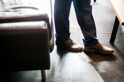 Low section of man standing on floor