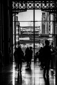 Rear view of silhouette people walking in city