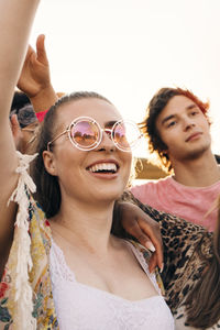 Man and woman cheering while enjoying music festival