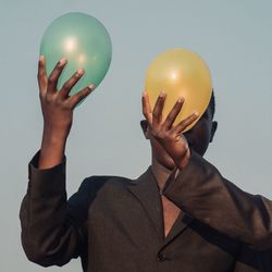 Midsection of man with balloons