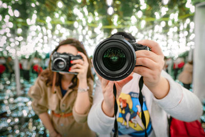 Women taking photos in mirror maze