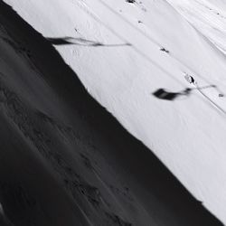 High angle view of footprints on snow covered landscape