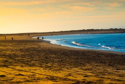 Scenic view of beach against sky during sunset