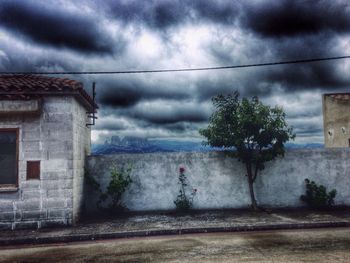 Low angle view of building against cloudy sky