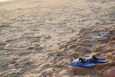 Flip flops on sand at beach