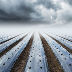 Surface level of road against sky during winter