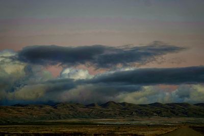 Scenic view of rainbow over mountains against sky