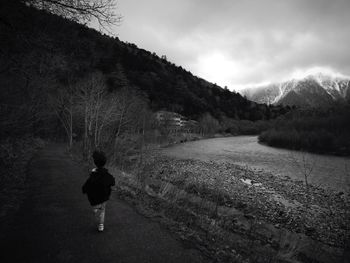 Scenic view of child running on footpath in kamikochi