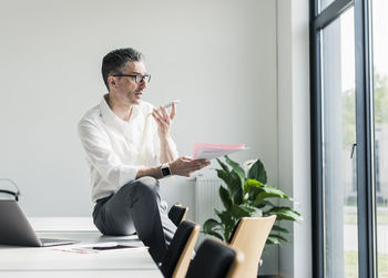 Businessman using cell phone in a conference room