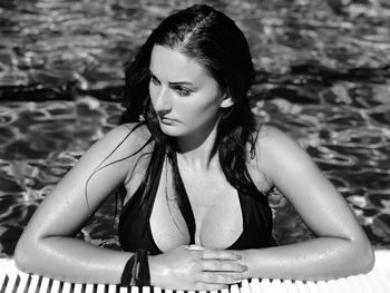 Thoughtful young woman in swimming pool