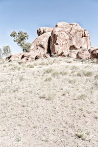 Rock formations on landscape against clear sky