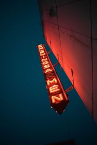 Low angle view of illuminated lighting equipment at night