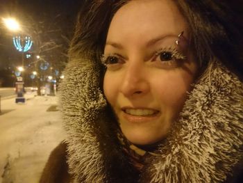 Portrait of smiling woman with snow