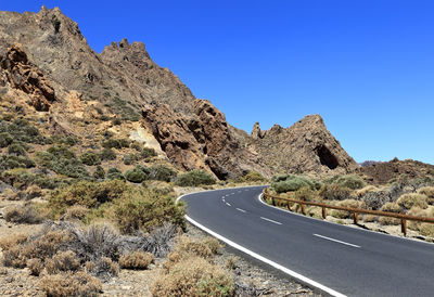 Road amidst rocks against clear sky