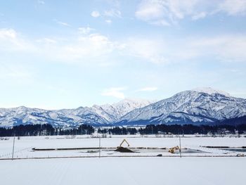 View of snow covered landscape with mountains in winter