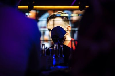 Rear view of people at illuminated restaurant