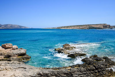 Scenic view of sea against clear blue sky