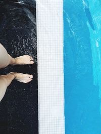 Low section of woman swimming in pool