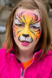 Close-up portrait of smiling teenage girl with face paint in event