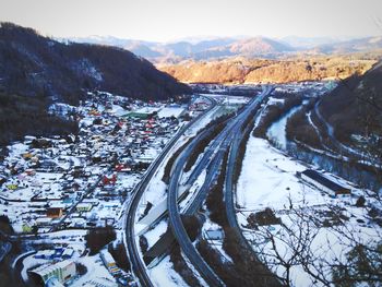 High angle view of snowcapped mountains against sky