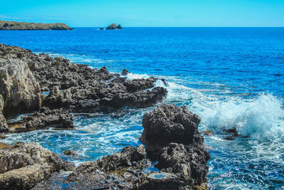 Scenic view of sea against rocks