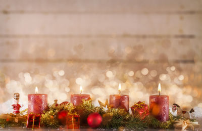 Close-up of illuminated candles on table