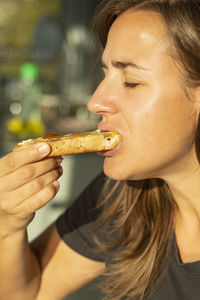 Close-up of young woman eating food