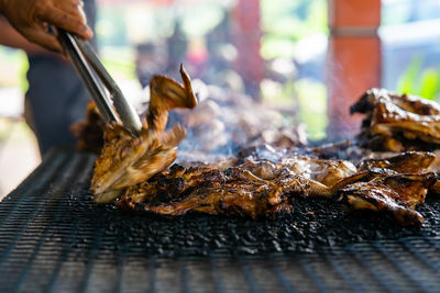 Ayam bakar or charcoal-grilled chicken. ayam bakar means roasted chicken, smoky burning process.