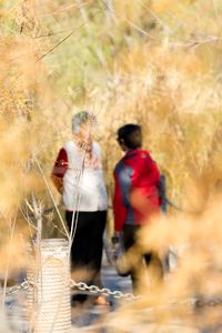 Rear view of people walking outdoors
