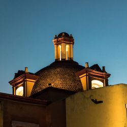 Low angle view of bell tower against clear sky