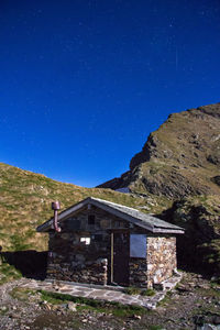 House against clear blue sky at night