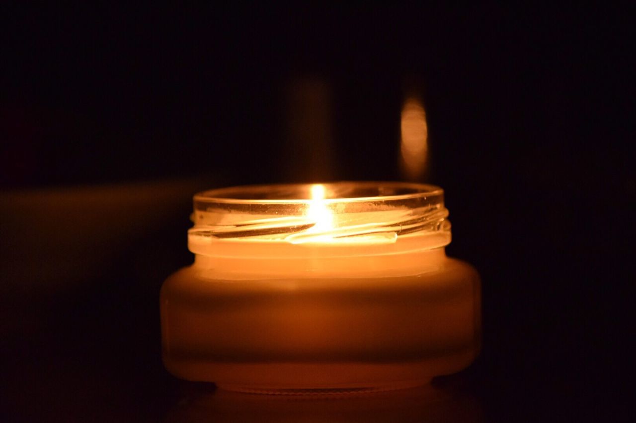 flame, burning, candle, glowing, heat - temperature, fire - natural phenomenon, illuminated, close-up, indoors, lit, dark, copy space, studio shot, candlelight, fire, darkroom, black background, glass - material, night, tea light