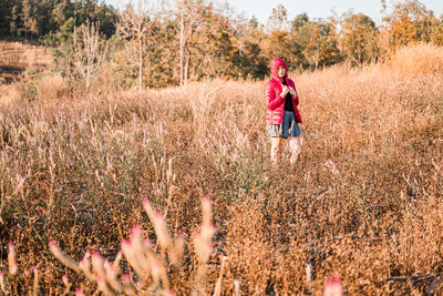 Full length of woman walking on field