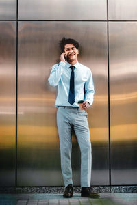 Man looking at camera while standing against sky