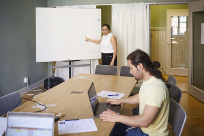 Coworkers in boardroom having meeting