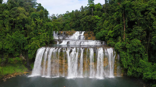 Beautiful waterfall in green forest, top view. tropical tinuy-an falls in mountain jungle
