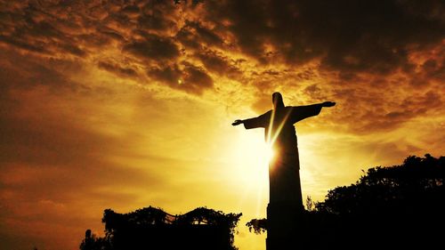 Low angle view of silhouette person against sky during sunset