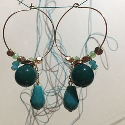 Close-up of earrings hanging from string
