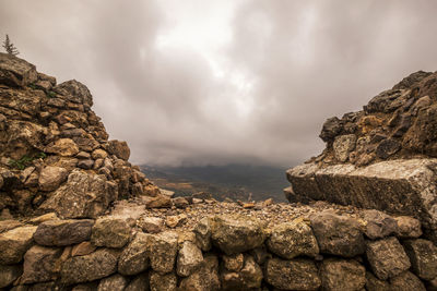 Low angle view of rock formation against sky